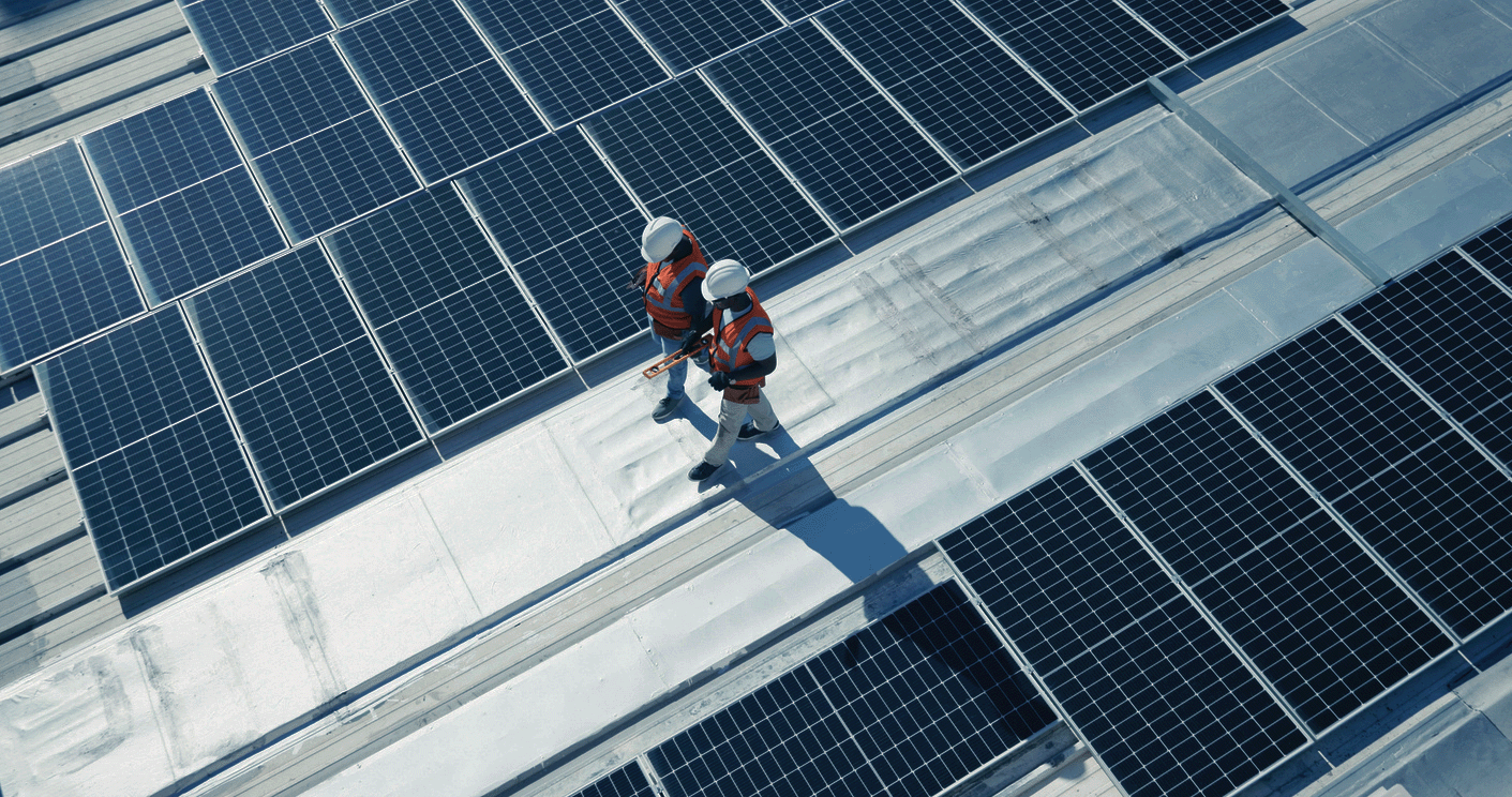 Men walking on roof near solar iStock-1665925516